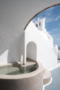 a view of a white building with a window at Valsamo Suites in Pirgos