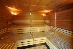 an empty sauna with wooden walls and wooden ceilings at Alpine Hotel Perren in Zermatt