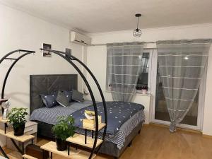 a bedroom with a bed and a window at Kula Apartman in Brčko