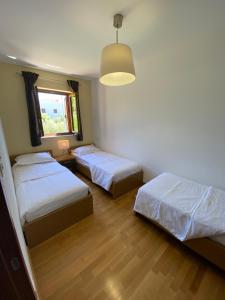 a bedroom with two beds and a window at Apartments Braje in Rabac