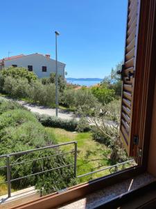 a view from a window of a yard at Apartments Braje in Rabac