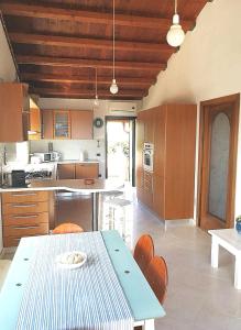 a kitchen with a blue table and chairs in it at Villa Arenella in Vieste