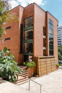 a brick building with stairs in front of it at Hotel Bambu Milla De Oro in Medellín