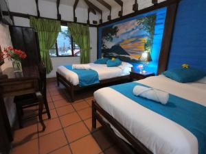 Letto o letti in una camera di Hostal Inti Luna