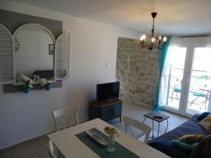 Televízia a/alebo spoločenská miestnosť v ubytovaní Charming apartment piccolo paradiso