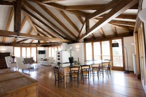 a living room with a dining room table and chairs at Comelico Chalet in Padola