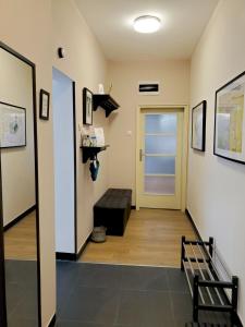a hallway with a door and a bench in a room at Sunny Central Apartment in Sofia