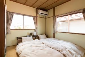 Un pat sau paturi într-o cameră la tathata - Vacation STAY 38756v