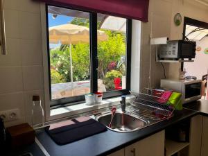 a kitchen counter with a sink and a window at Casa Beatriz in Playa Blanca