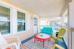 a porch with chairs and a table on a porch at Brooklyn's Casa Rosa & Hitch Apartment in Ocean City