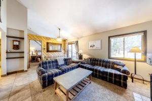 a living room with two couches and a table at Flying Dutchman Condos in Keystone