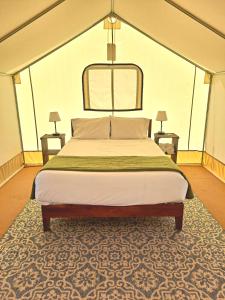 a bedroom with a bed and a chair at Wildhaven Sonoma Glamping in Healdsburg