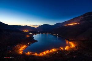 a view of a lake at night with city lights at BEST HOUSE CAMPO DI GIOVE in Campo di Giove