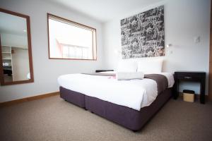 a bedroom with a large bed and a mirror at Itoku in Kutchan