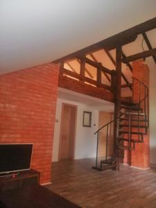 索科礦泉村的住宿－Apartman Daša，一间设有砖墙和螺旋楼梯的房间
