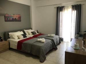 a bedroom with a large bed with towels on it at Heaven Studios & Apartments in Stalís