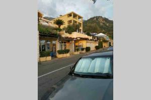a car parked on the side of a street at BMV room for 2-3 with greenery view in Sveti Stefan +1 photo