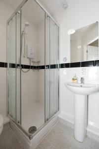 a bathroom with a shower and a sink at The Pickering Park Hotel in Hull