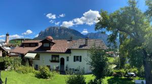 a house with a mountain in the background at Apartments Garni Steffi in Völs am Schlern