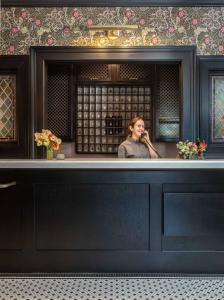 a woman standing at a bar in a restaurant at National Exchange Hotel in Nevada City