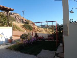 a garden with a hill in the background at Villa Giorgos in Kefalos