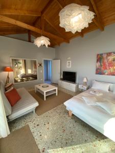 a bedroom with a large bed and a living room at Sea House Kitries in Kitriaí