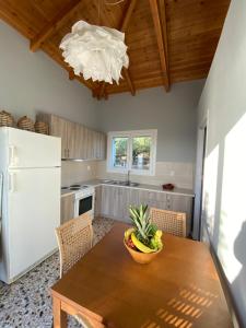a kitchen with a table with a bowl of fruit on it at Sea House Kitries in Kitriaí +33 photos