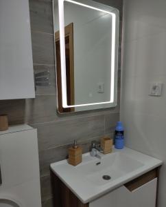 a bathroom with a sink and a mirror at Lux Apartman Lea - Vila Esla 1 in Zlatibor +14 photos
