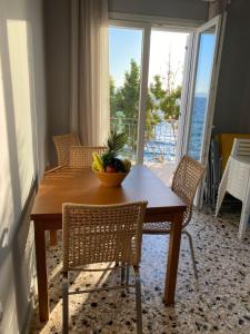 a dining room table with a bowl of fruit on it at Sea House Kitries in Kitriaí
