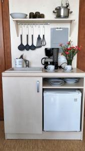 a kitchen with a white counter with utensils at Dom Gościnny Harpun in Władysławowo