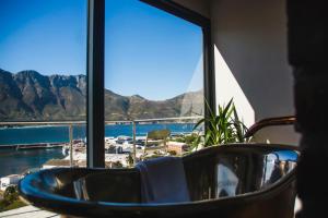 a room with a view of the ocean and mountains at Best Place Ever in Hout Bay