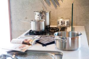 a kitchen counter with pots and pans on a stove at Yume Basho in Kutchan