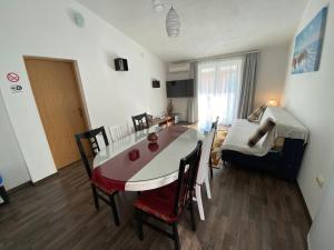 a living room with a table and chairs and a dining room at Ana Marija in Solin