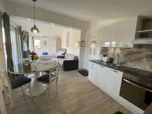 a kitchen and living room with a table and a couch at Ana Marija in Solin