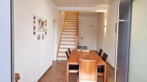 a dining room with a wooden table and chairs at Waldblick in Bremke
