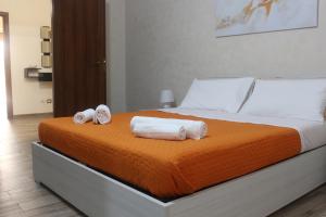 a bedroom with a bed with towels on it at Casa Colapesce in Messina