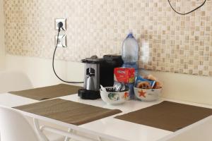 a kitchen counter with a coffee maker and food on it at Casa Colapesce in Messina