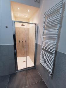 a shower with a glass door in a bathroom at Casa Remo - dolce soggiorno nella Piazza di Greve in Greve in Chianti