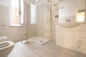 a bathroom with a toilet and a sink and a shower at Willy's apartment in Manarola