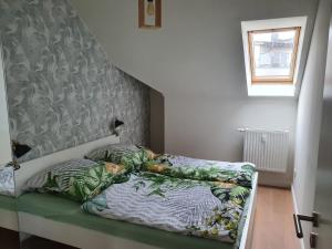 a bed sitting in a room with a staircase at FeWo Lust auf Laboe in Laboe