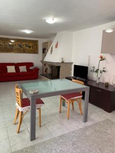 een woonkamer met een tafel en 2 stoelen bij Viniola Apartment in Quartu SantʼElena