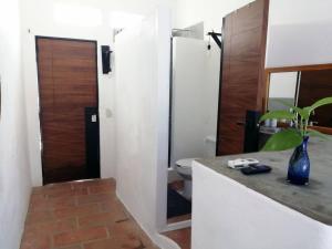 a bathroom with a sink and a toilet and a mirror at Estudio sobre calle principal con vista a la plaza in Sayulita