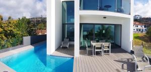 two pictures of a house with a swimming pool at Sunshine Villa 150m above Ocean & Sandy Beach in Estreito da Calheta
