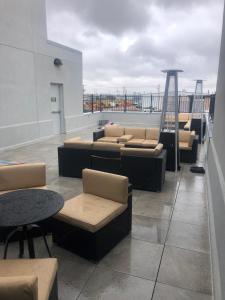 a room with couches and tables on a roof at Hotel 21 in Gering