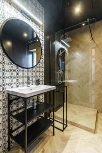 a bathroom with a sink and a mirror at Loftowy apartament w sercu Śląska in Ruda Śląska