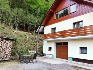 a house with a table and chairs in front of it at Seeblick Krippenstein in Obertraun