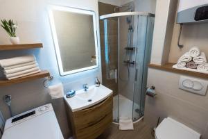 a bathroom with a shower and a sink and a toilet at N & D in Šibenik +52 photos