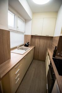 a kitchen with white cabinets and a sink at N & D in Šibenik
