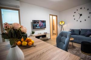 a living room with a table and a blue couch at N & D in Šibenik