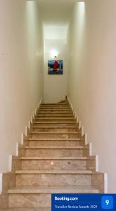 a staircase in a building with a picture on the wall at Appartamento Marconi 13 in San Vito lo Capo